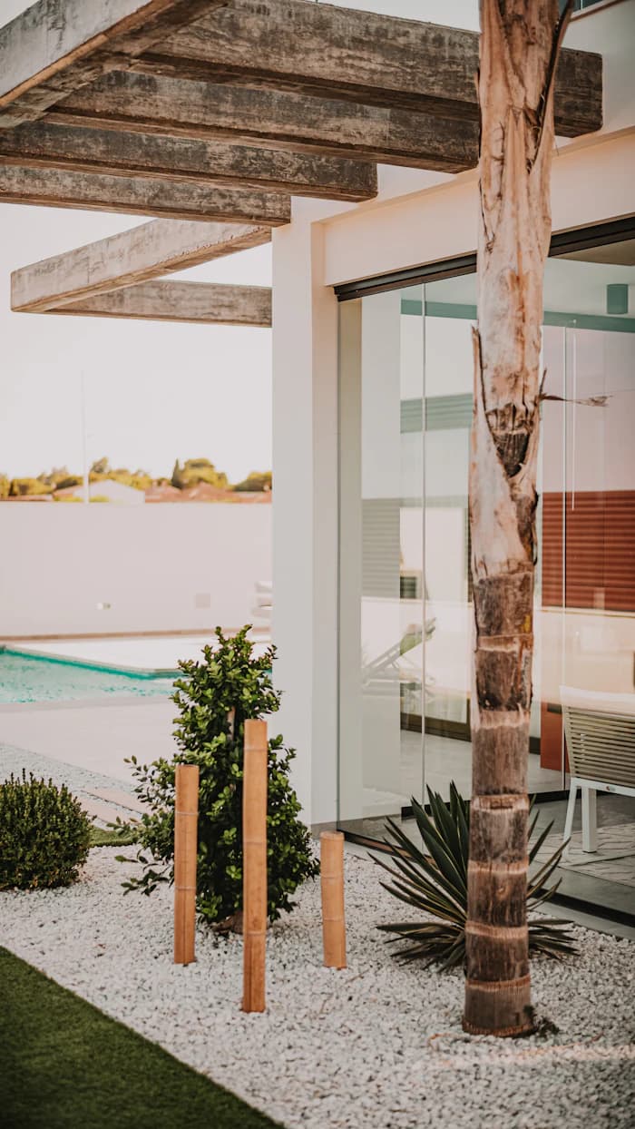 A welcoming courtyard with a shaded timber pergola beside a pool